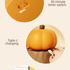 An orange silicone pumpkin night light with a timer switch and Type-C charging port.
