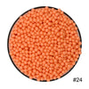 A pile of 300 colorful orange water beads in a circular container.
