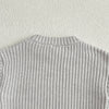 A close-up of a light gray soft cotton knit baby pullover sweater.