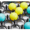 A collection of bright yellow and blue plastic bounce balls arranged in a black grid for a tabletop game.