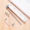 Stainless steel automatic door closer with an invisible spring mechanism and mounting hardware on a wooden surface.