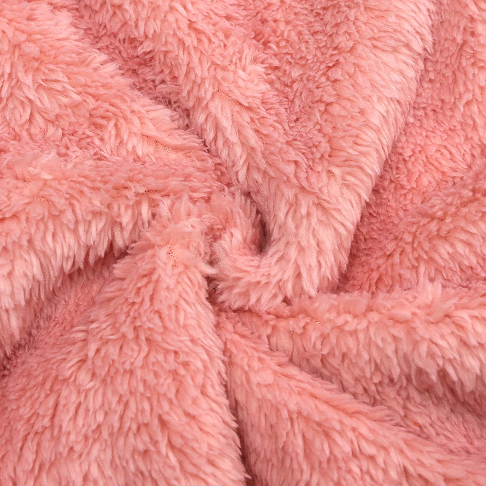 Close-up of a pink baby fleece hooded romper with a zipper, showing the soft texture and folds.