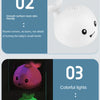 A white musical whale bath toy with light-up features is shown in a product comparison layout.