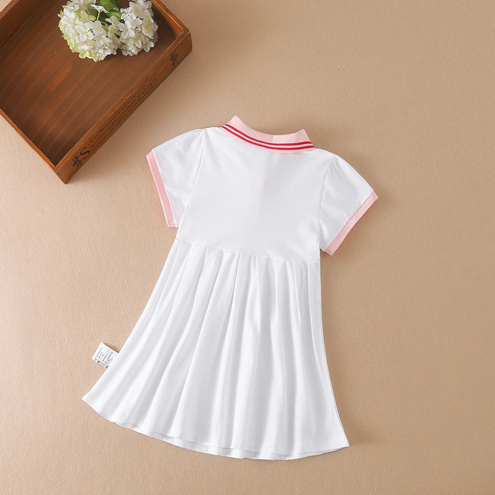 White kids summer cotton dress with a red and white turn-down collar displayed on a neutral background.