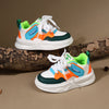 A pair of kids' breathable casual sneakers featuring white, teal, orange, and green accents on a light brown background.