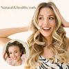 A woman shows off natural and healthy curls while wearing a heatless overnight curling headband.
