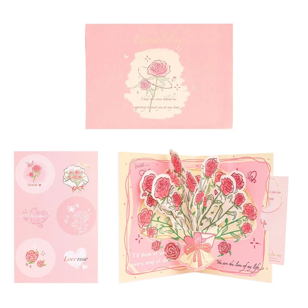 A pink pop-up card featuring a love tree design and a couple silhouette illustration.