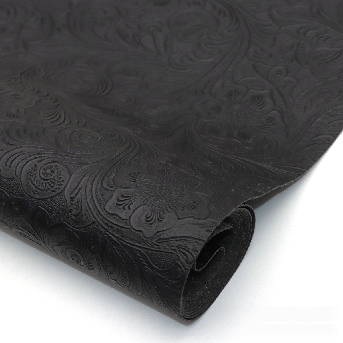 Black vintage floral textured faux leather fabric rolled for handcrafted projects