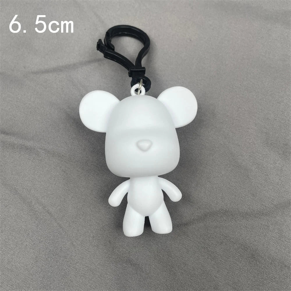 A white bear figurine with black hanging loop, shown against a gray background.