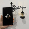 A black metal scrollwork lantern shelf lamp with a glass globe is displayed against a white background.