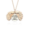 A gold-toned locket necklace featuring a sunflower pendant with engraved text.
