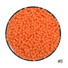 A circular arrangement of small, orange water beads.