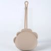 A beige silicone pacifier storage case with a lanyard attached, featuring a rounded design.