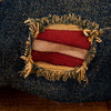 Baseballkasket i vintage slidt denim med flagdesign i røde og hvide striber.