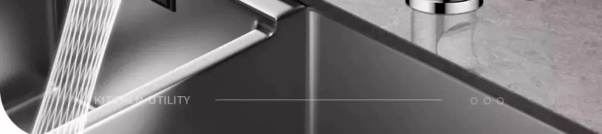 A close-up view of a stainless steel kitchen faucet extender sprayer being used in a sink.