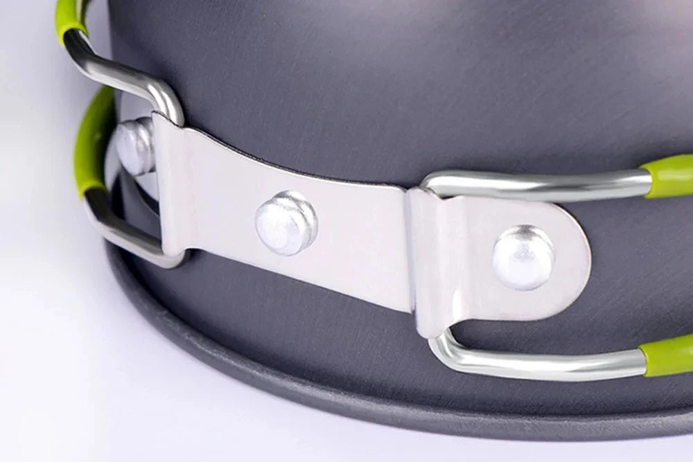 Silver and lime green ultralight camping cookware mess kit with a strap