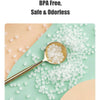 A spoonful of clear, gel-like material is shown on a spoon against a light green background.