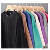 A rack of various colored heavyweight cotton oversized t-shirts hanging on wooden hangers.