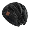 Black knit beanie with a multicolor geometric pattern, shown from the side.