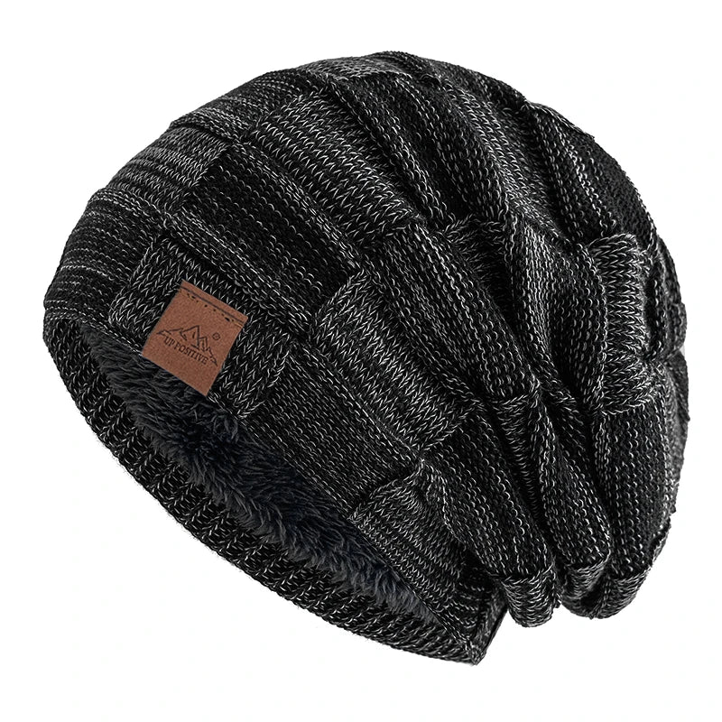 Black knit beanie with a multicolor geometric pattern, shown from the side.