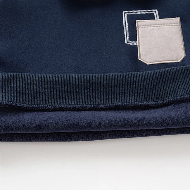 Navy fleece pullover sweatshirt with a light gray pocket detail and ribbed collar.
