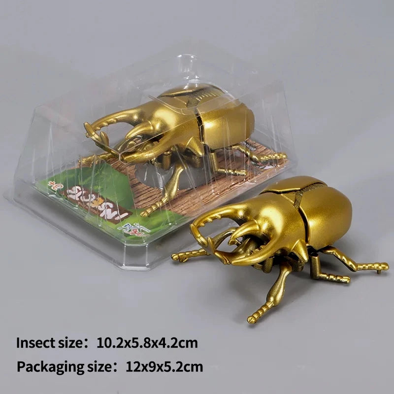 A golden wind-up insect toy, resembling a beetle or bee, is shown inside clear plastic packaging.