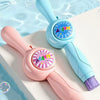 A pink and blue bubble wand is shown floating in water with a cute design.