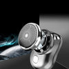 A close-up of a silver mini shaver with a mesh head is shown against a dark background.
