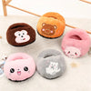 A collection of five plush, round foot warmers in various colors and animal designs resting on a white surface.