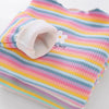 A pink and multicolored striped t-shirt with a white flower print, folded to show the neckline.