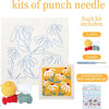 Punch needle embroidery kit featuring a yellow and white floral design with yarn and tools