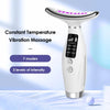 A white LED light therapy neck and face massager with vibration modes displayed on a surface.