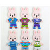 A set of four wooden puzzle dress-up bears for children, featuring different outfits and expressions.