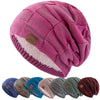 A pink knit beanie with a multicolored pattern and a light pink sherpa lining is shown from above.