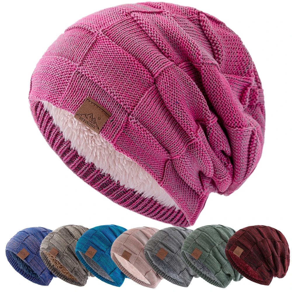 A pink knit beanie with a multicolored pattern and a light pink sherpa lining is shown from above.