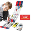 A wooden track set for racing cars with four launchers and eight cars, including a boy interacting with the product.