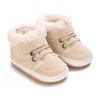 Pair of beige faux fur baby winter snow boots for toddlers with light tan leather accents