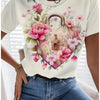 A woman wearing a white t-shirt with a pink and green rose floral print, paired with blue jeans.