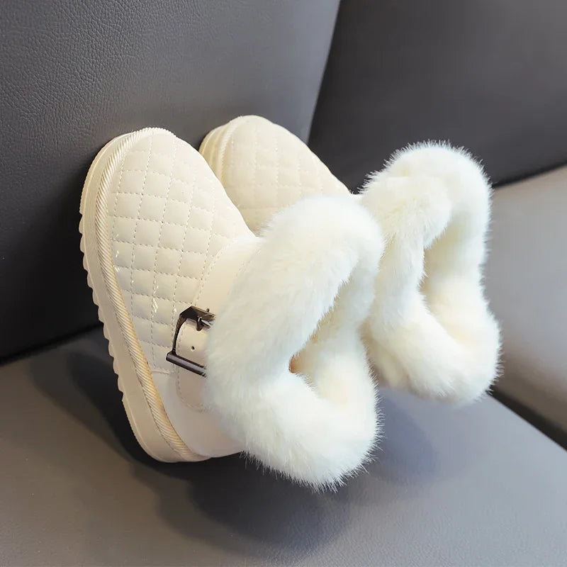 A pair of cream-colored winter snow boots with quilted fabric and fluffy white faux fur trim.
