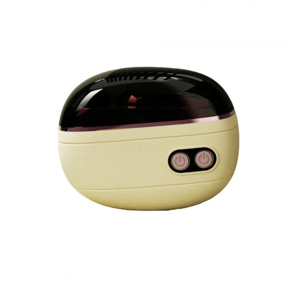 A round, black and beige electric nail clipper and grinder with a visible power switch.