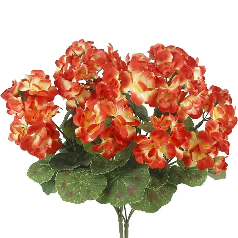 Lifelike red artificial geranium bouquet with orange and yellow blooms on green leaves