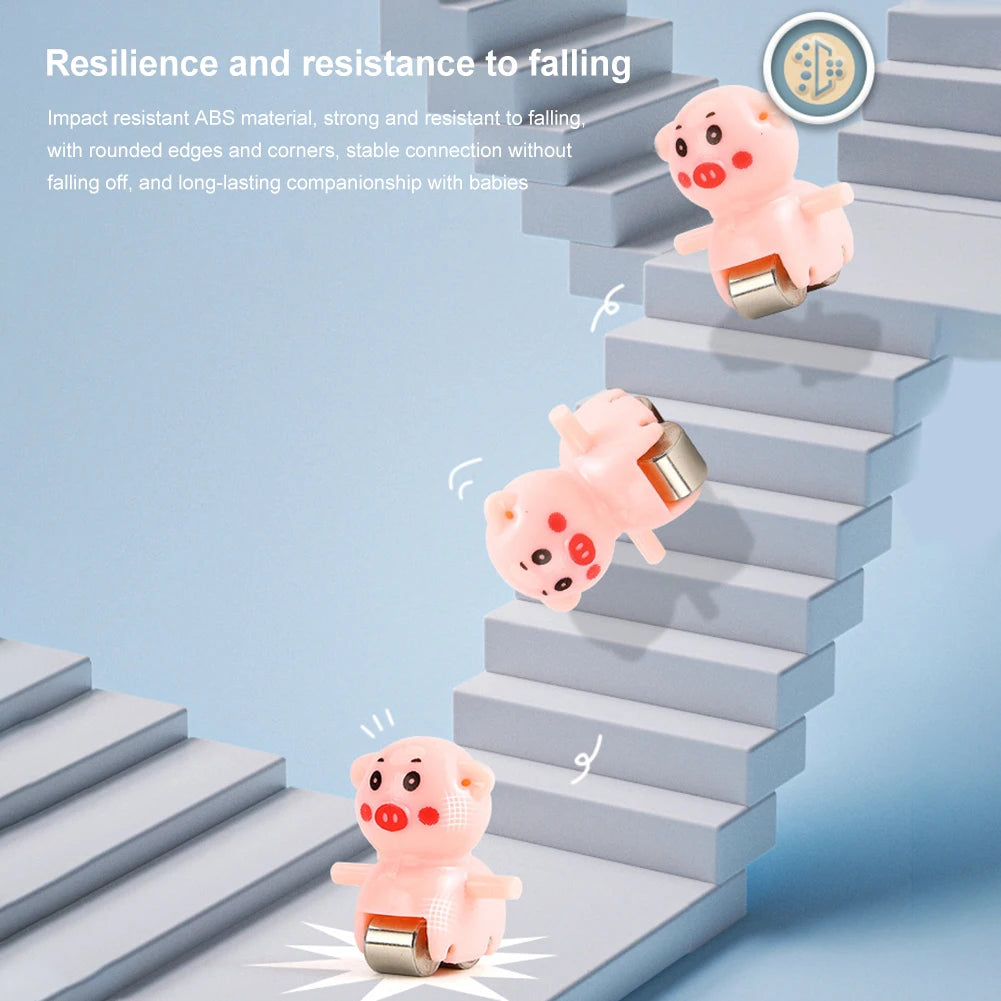 Pink piggy shaped toy cars climbing a set of gray stairs