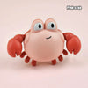 A pink crab bath toy with large eyes and orange claws
