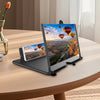 A portable 3D phone screen magnifier is shown displaying a vibrant scene of hot air balloons over mountains.