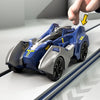 A blue and silver transforming dinosaur car toy is shown on a track, with a hand pushing it.