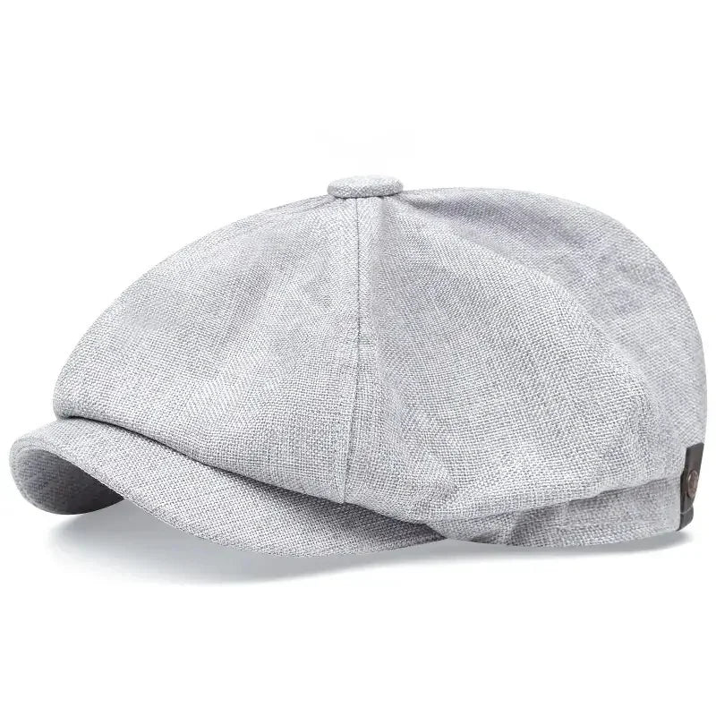 A grey vintage retro newsboy cap with a folded brim shown from the side.