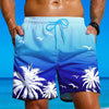 A muscular man wearing blue tropical palm print drawstring swim trunks standing near the ocean.