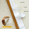 Close-up view of a white adhesive layer and paste layer on a brown sisal mat for furniture attachment.