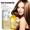 A woman shows off long brown hair while holding a bottle of EELHOE Rosemary Hair Essential Oil.