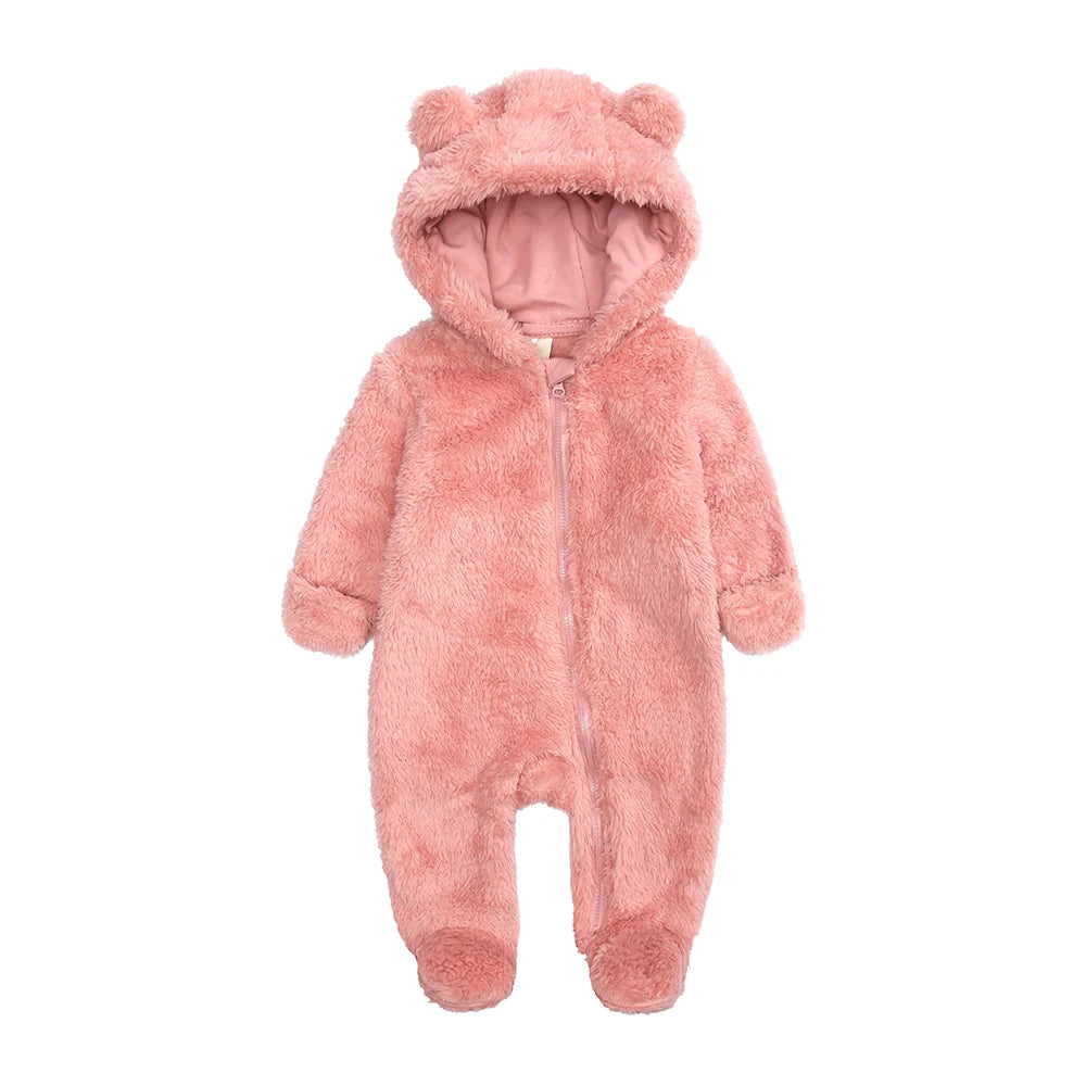 A pink fuzzy fleece hooded romper for a baby with a zipper closure.